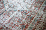 Distressed texture of a vintage Malayer rug, highlighting blanched silver and teal colors.