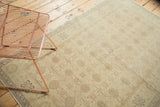 Vintage Sivas rug corner, interlaced palmettes in soft gold, ivory, beige, and sand with fringe.