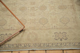 Corner of vintage Turkish Sivas rug, soft gold and beige tones, interlaced palmettes, and secure border.
