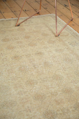 Muted interlaced palmette and vine motifs on the soft gold field of a vintage Sivas rug.