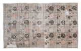 Vintage Distressed Oushak rug with black rose motif in silver, rose beige, and dark charcoal.