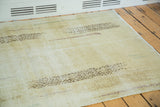 Worn texture and modern abstract brown stripes on the distressed lemon ivory Oushak rug.