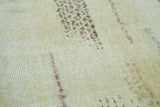 Distressed Oushak rug texture, abstract modern lines in faded brown on lemon ivory.