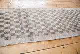 Shaggy pile texture with tone-on-tone earthy silver and tan checkerboard design.