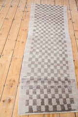 Geometric checkerboard pattern and hand-knotted texture of a vintage Tulu runner.