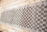 Textured checkerboard design of the vintage Tulu runner in tone-on-tone earthy beige and charcoal.