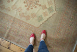 Vintage Turkish Oushak carpet with soft pastel geometric patterns and ornate border.