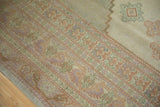 Pastel green, soft lavender, and terracotta geometric motifs on a vintage Oushak carpet.