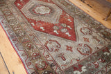 Rusty bronze lozenge motifs and geometric border patterns on a vintage Oushak runner.