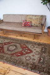 Vintage Oushak runner's rusty bronze lozenge field and silver grey ivory border.