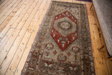 Close-up of the vintage Oushak runner's rusty bronze lozenge field and soft grey border motifs.