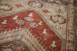 Rusty bronze field with soft silver grey and ivory geometric border patterns.