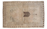 Vintage Oushak rug with central charcoal arrow and beige tribal geometric pattern, 4'1