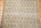 Repeating slate blue and beige geometric motifs on a vintage Oushak rug.