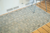 Textural view of vintage Oushak runner's repeating geometric pattern in silver and beige.