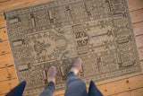 Geometric charcoal and faded aqua patterns on a blanched vintage Oushak rug.