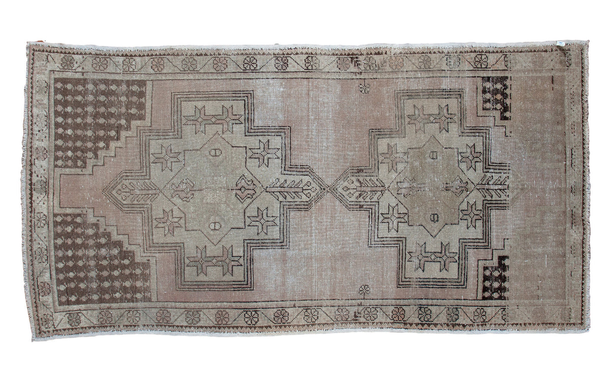 Vintage geometric Oushak rug in neutral beige, brown, and rose colors, 4'3" x 8'4".
