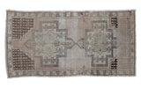 Vintage geometric Oushak rug in neutral beige, brown, and rose colors, 4'3