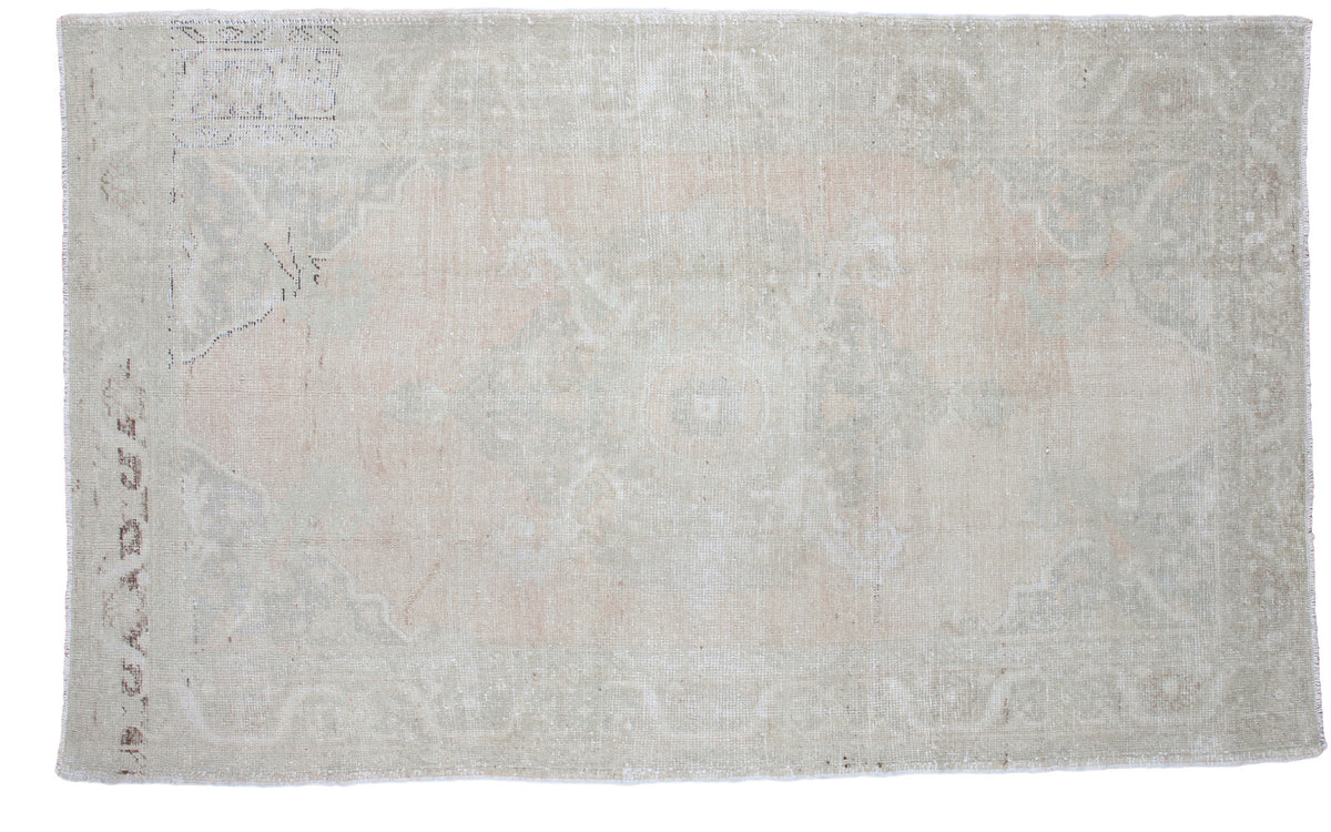 Subtle light and airy vintage Oushak rug featuring a faded traditional medallion pattern in pale beige and blush, 5' x 8'1".