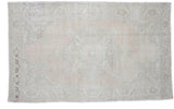 Subtle light and airy vintage Oushak rug featuring a faded traditional medallion pattern in pale beige and blush, 5' x 8'1