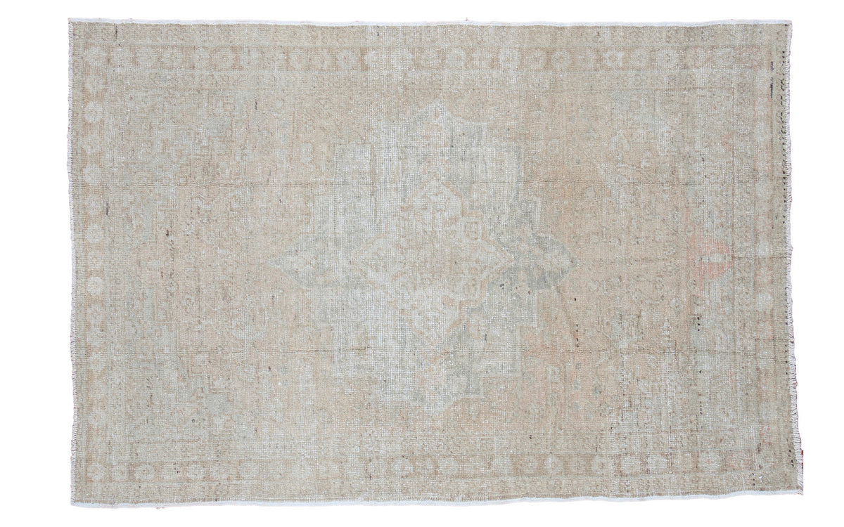 Subtle light and airy vintage Oushak rug with a faded medallion design.