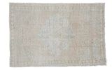 Subtle light and airy vintage Oushak rug with a faded medallion design.