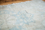 Blanched ivory and powder blue pattern on an airy vintage Oushak rug.
