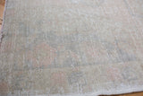 Blanched beige and faded pink texture visible on this distressed Oushak rug.