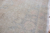 Distressed vintage Oushak rug with blanched beige and faded pastel texture.