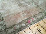 Textured pile of vintage Oushak rug border with geometric soft bronze and cotton candy pink.