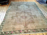High sheen pile of vintage Oushak rug with stylized geometric border and pink accents.