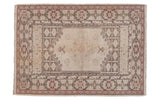 Light ivory vintage Oushak rug with peach and dark charcoal geometric borders. 3x4.