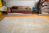 Distressed Oushak carpet displaying airy light beige tones and faded blue design.
