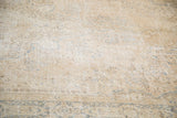 Light beige distressed pile of a vintage Oushak rug with soft blue patterns.