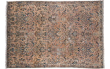 Distressed antique Persian Kerman carpet with sprawling palmettes and samovar motifs in faded peach and blue.