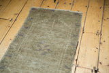 Muted grey-green vintage Oushak rug pile with subtle patterns and soft texture.