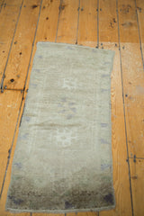 Vintage Oushak rug's lower section, subtle grey pattern, and darker fringed edge.
