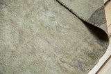 Textured pile and sturdy hand-knotted back of a vintage Oushak rug, subtle grey tones.