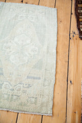 Soft woven texture and muted abrash colors along the edge of a vintage Oushak runner.