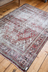 Joshegan rug's deep red and muted tones, showcasing its unique textured, distressed pile.