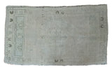 Vintage Turkish Oushak rug in blanched silver and sea foam green with stylized patterns.