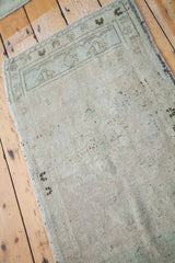 Blanched silver and sea foam green low pile texture of vintage Oushak rug.