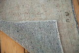 Turkish Oushak rug corner with dense hand-knotted backing and blanched silver pile.