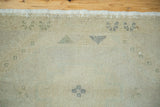 Vintage Oushak rug's hand-knotted pile with blanched ivory, beige, and subtle geometric motifs.