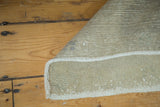 Hand-knotted foundation and woven back of a vintage Oushak rug with neutral tones.