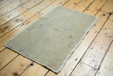 Blanched ivory, beige, and silver tones on a vintage Oushak rug with subtle patterns.