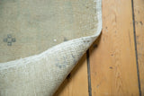 Hand-knotted foundation and tightly finished edge of the blanched Oushak rug.