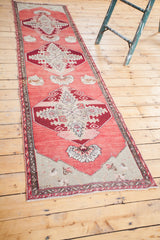 Vintage Oushak runner detail: ruby red medallion, cranberry field, silver spandrel, leaf borders.