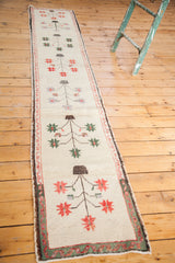 Vintage Oushak runner with repeating whimsical tree of life motifs on pale ivory.