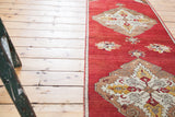 Bronze, ivory, saffron yellow medallion with floral motifs on cherry red Oushak.